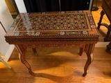 a wooden table with a glass top on a hard wood floor