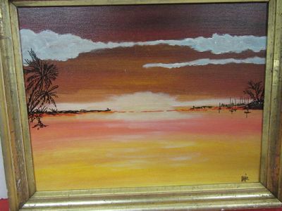 a picture of a painting of a sunset in a gold frame