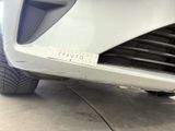 a close up of a car ' s front bumper with a sticker on it