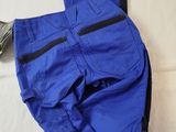 a pair of blue pants laying on top of a bed