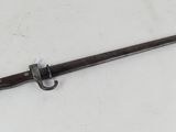 an old sword with a wooden handle on a white surface