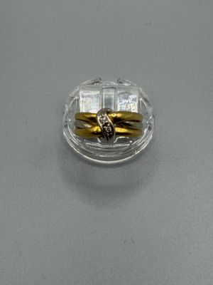 two rings sitting in a clear container on a table