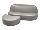 a grey couch and ottoman sitting on a white surface