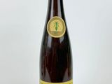 a bottle of wine sitting on top of a white table