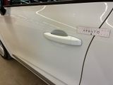 a close up of a car door handle with a sticker on it