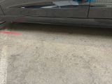 the car is parked on the side of the street in front of a building