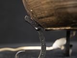 a close up of a metal object on a black surface