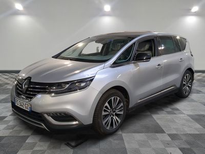 a silver car is parked in a room with checkered floor