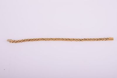 a gold bracelet on a white background
