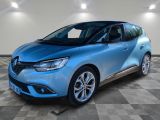 une voiture bleue est garée dans une grande pièce au sol en damier