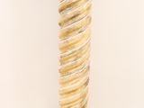 a close up of a tall glass vase on a white surface