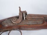 an old gun that is on display on a table