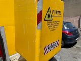 a large yellow box sitting on the back of a truck