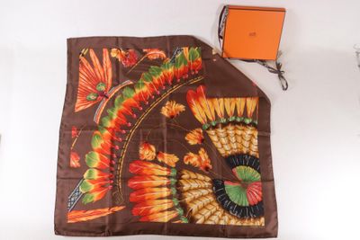 a scarf with a design on it next to an orange box