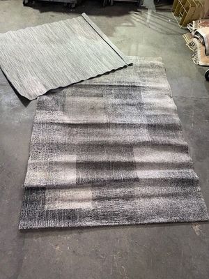two rugs that are on the floor in a store