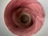 a picture of a pink vase with a swirl in it