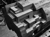 black and white photograph of a bench made out of wood with letters carved into it