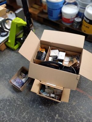 a cardboard box filled with electronic equipment on a table