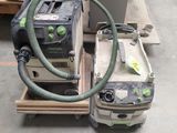a green and black duster and a black and white vacuum