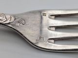 a close up of a fork on a table