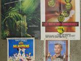 several movie posters on a wall in a room