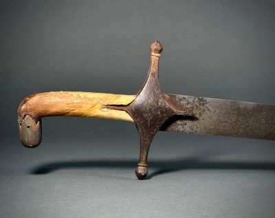 a close up of a knife with a wooden handle