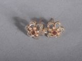 pair of gold tone earrings with pearls and garnets