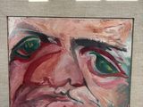 painting of a man ' s face with green eyes in a frame
