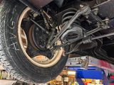 a picture of a car being worked on by a mechanic