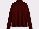 a women ' s turtle neck sweater in a dark red color