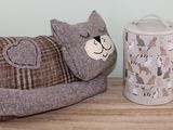 a stuffed animal next to a mug on a table