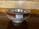 a silver bowl on a table with a price tag on it