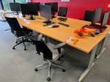 many computers on the desk in this office