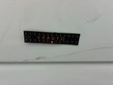 a close up of a sticker on the side of a white refrigerator