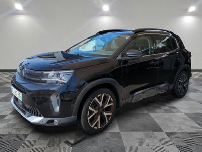 a black suv parked in a room with a checkered floor