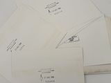 several envelopes are stacked on top of each other on a table