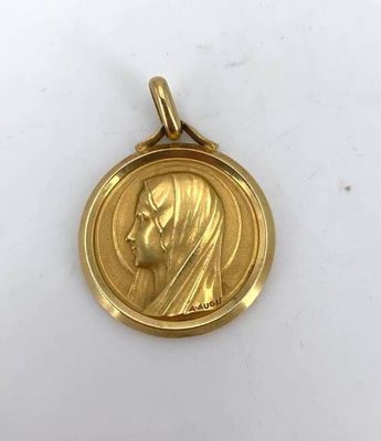 a close up of a gold medal with a woman ' s face on it