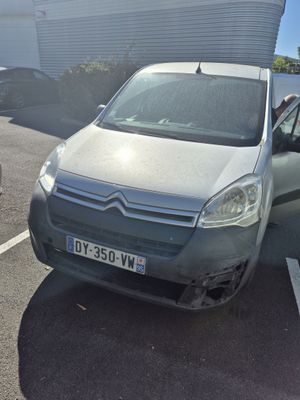 grey citroen van parked in a parking lot next to a building