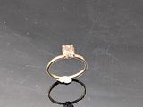 a gold ring with a white stone on top of it