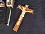 a crucifix and a bible on a table