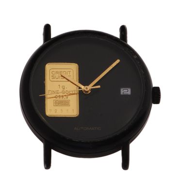 a close up of a black watch with a gold bar on the face