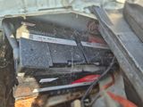 a car battery in the trunk of a truck
