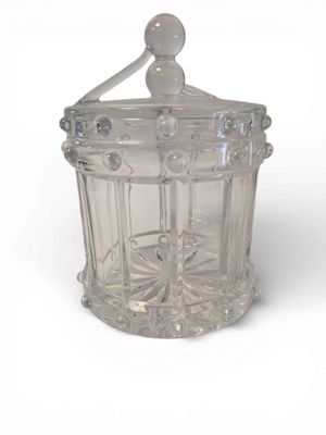 a clear glass jar with a lid on a white surface