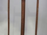 two wooden poles that are standing next to each other