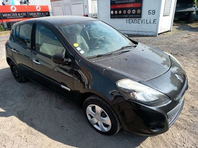 a picture of a small black car parked in front of a building