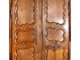 an image of a wooden armoire with ornate carvings on the doors