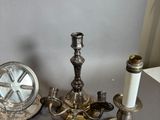 a lot of silverware on a table with a clock