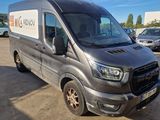 the grey van is parked in a parking lot with other cars