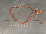 an image of a necklace, bracelet, and broochet set on a table