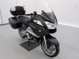 a black and silver motorcycle parked in a white room